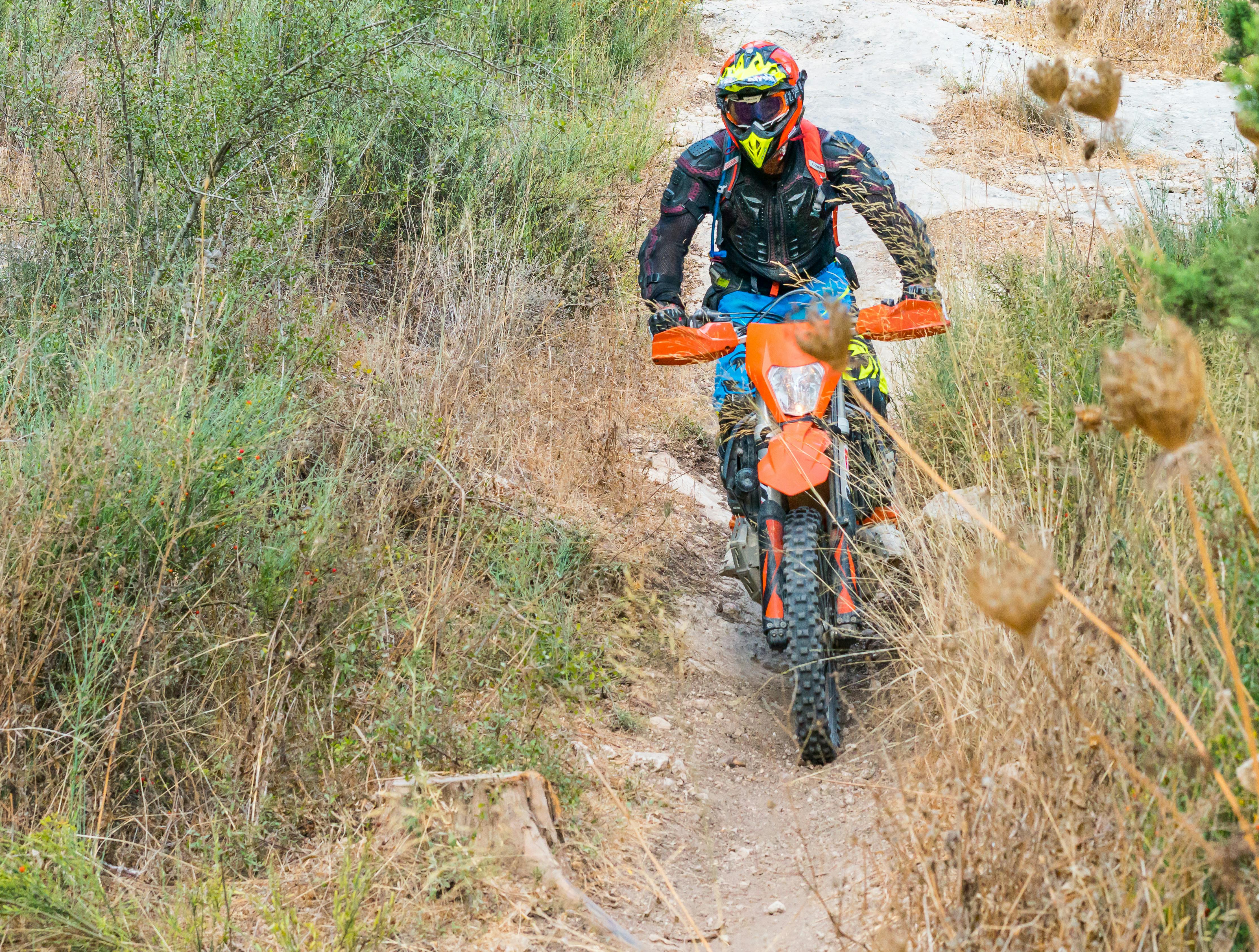 Rider navigating a rocky trail through Japanese forest
